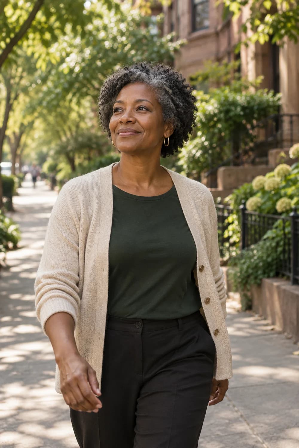 A woman enjoying a morning walk along a tree-lined street